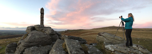 Anna photographing a stunning sunset from Brat Tor, Dartmoor