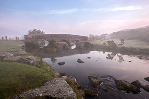 Clapper bridge shrouded in mist at Bellever, Dartmoor