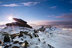 Logan stone at the top of snow covered Belstone Tor, Dartmoor